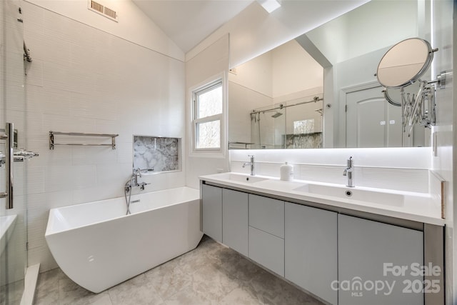 bathroom with lofted ceiling, plus walk in shower, and vanity