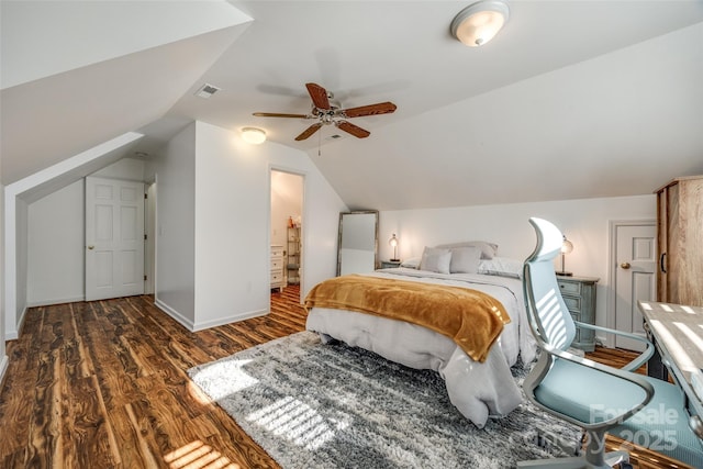 bedroom with ceiling fan, dark hardwood / wood-style flooring, and vaulted ceiling