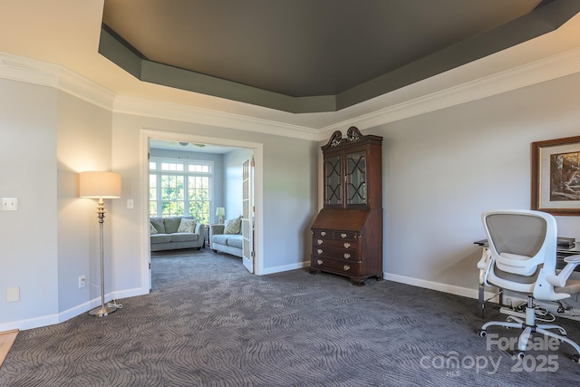 sitting room featuring dark carpet, ornamental molding, and a raised ceiling