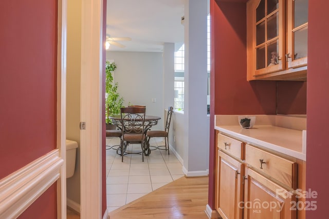 kitchen featuring ceiling fan and light hardwood / wood-style flooring