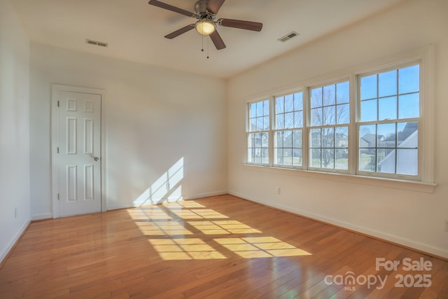 spare room with light hardwood / wood-style floors and ceiling fan