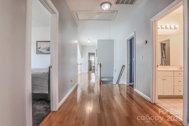 hallway with hardwood / wood-style flooring