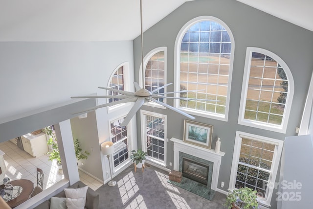 living room with high vaulted ceiling and a fireplace