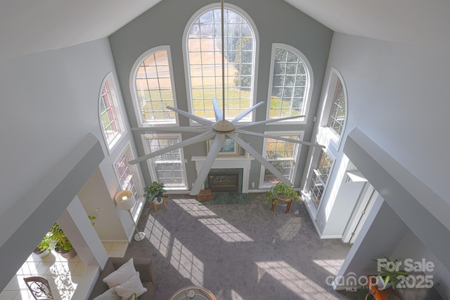 living room featuring high vaulted ceiling and a healthy amount of sunlight