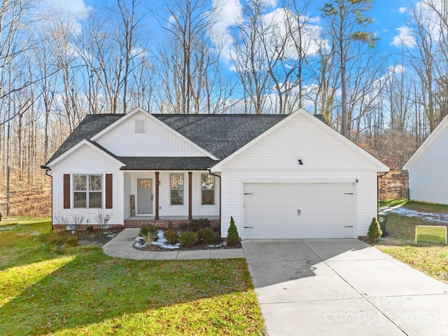 view of front of home with a front yard, covered porch, and a garage