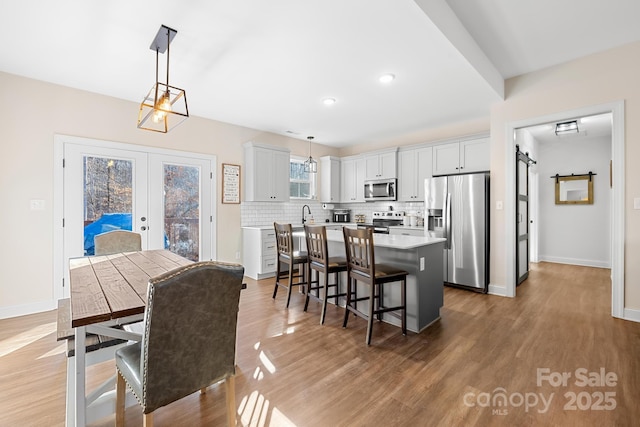 dining space featuring french doors and hardwood / wood-style floors