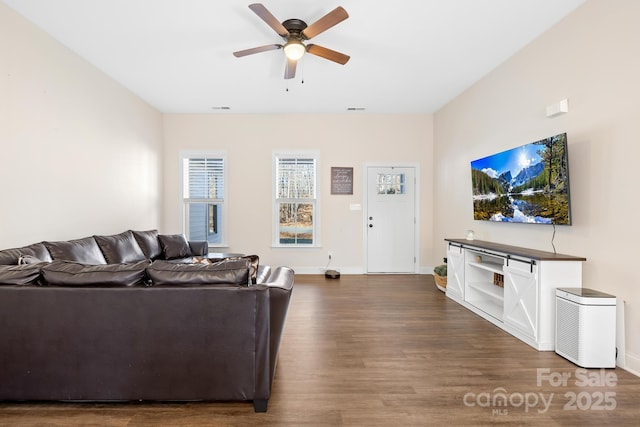 living room with ceiling fan and dark hardwood / wood-style flooring