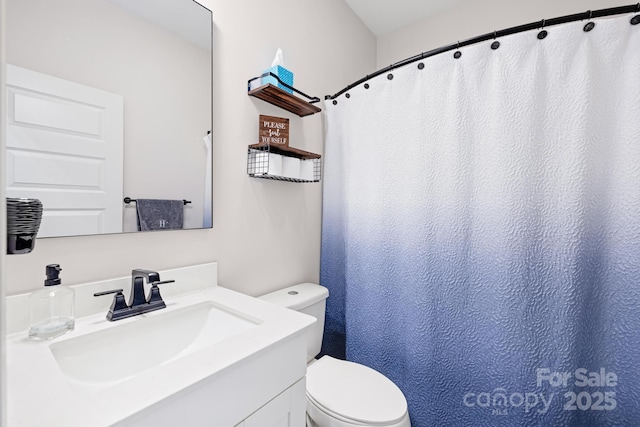 bathroom with toilet and vanity