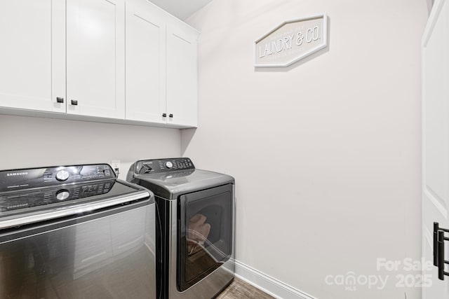 washroom featuring hardwood / wood-style flooring, cabinets, and independent washer and dryer