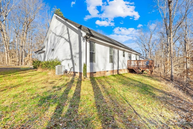 view of side of property featuring a wooden deck, central air condition unit, and a yard