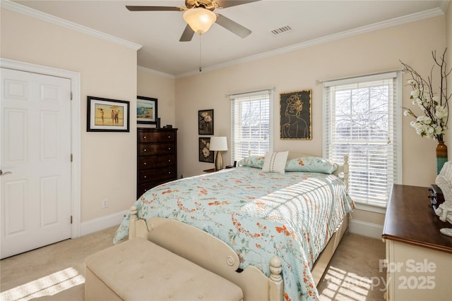 carpeted bedroom with ceiling fan and crown molding