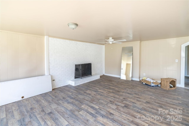 unfurnished living room with ceiling fan, a fireplace, and dark hardwood / wood-style floors