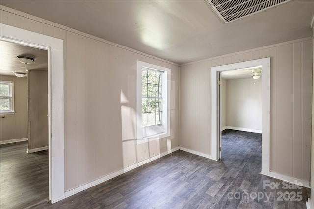 spare room with dark hardwood / wood-style flooring and ceiling fan