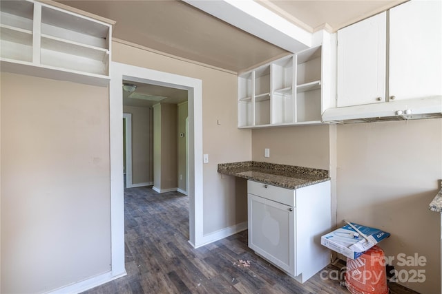 kitchen featuring dark stone counters, white cabinetry, and dark wood-type flooring