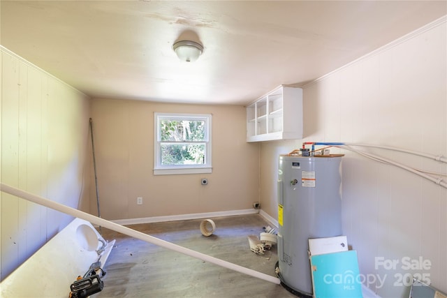 interior space with electric water heater and crown molding