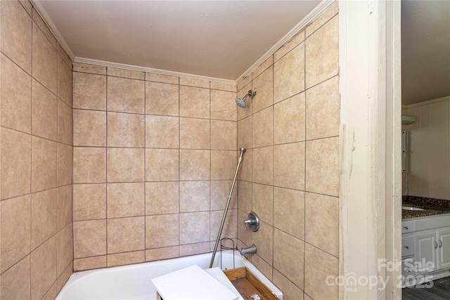 bathroom with vanity, tiled shower / bath combo, and ornamental molding