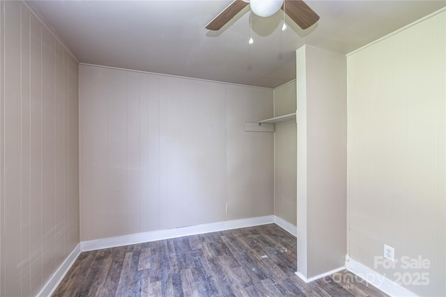 walk in closet with ceiling fan and dark wood-type flooring