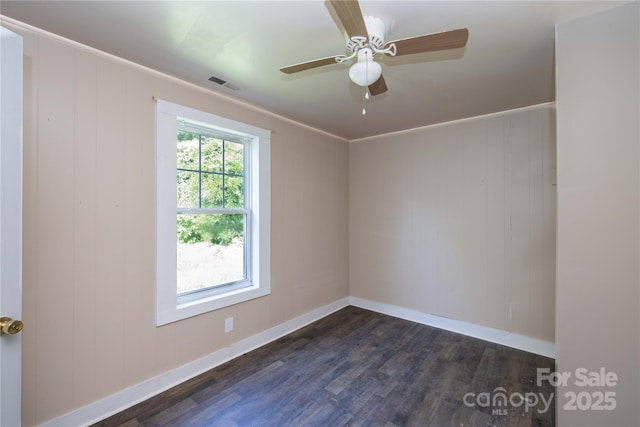 unfurnished room with ceiling fan, dark hardwood / wood-style flooring, and crown molding