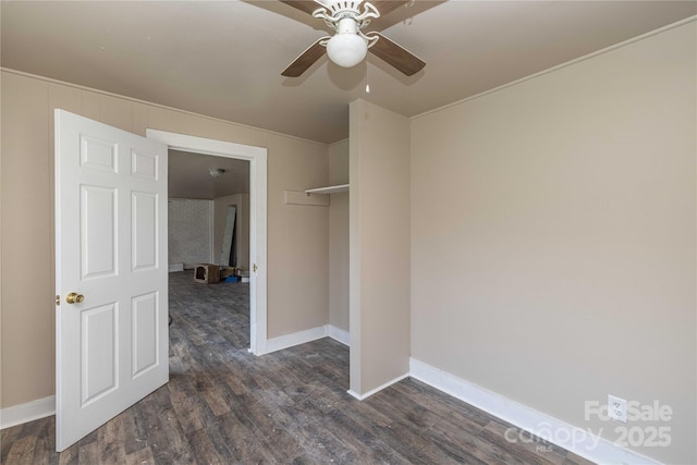 empty room with ceiling fan and dark wood-type flooring