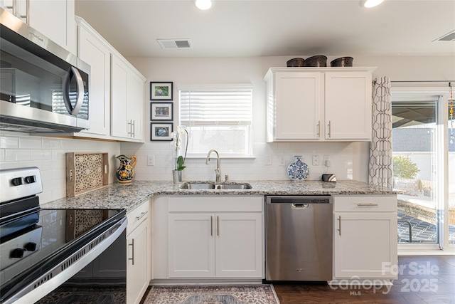 kitchen featuring stainless steel appliances and white cabinetry