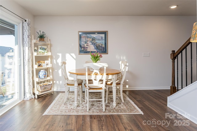 dining area featuring dark wood-type flooring