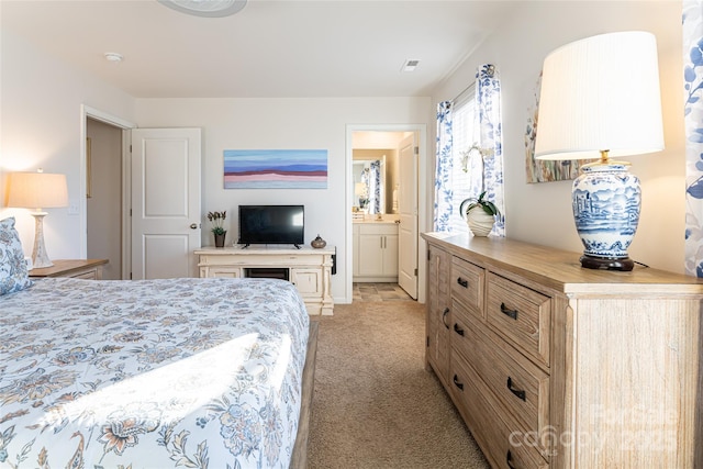 carpeted bedroom featuring connected bathroom