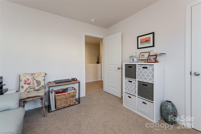 sitting room featuring light colored carpet