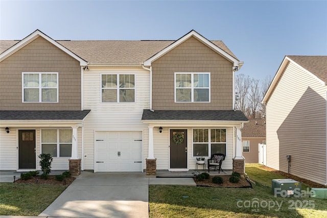 craftsman inspired home with a garage, a porch, driveway, and a shingled roof