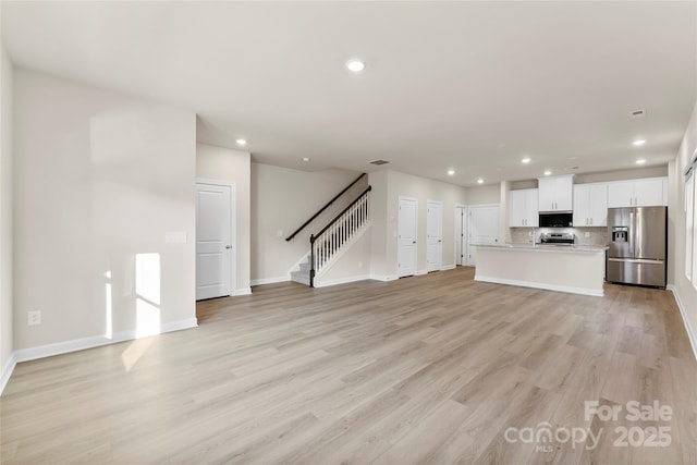 unfurnished living room with light hardwood / wood-style flooring