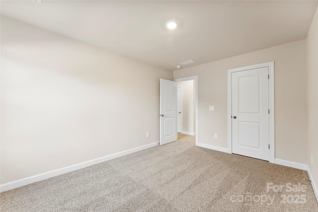 unfurnished bedroom with light colored carpet