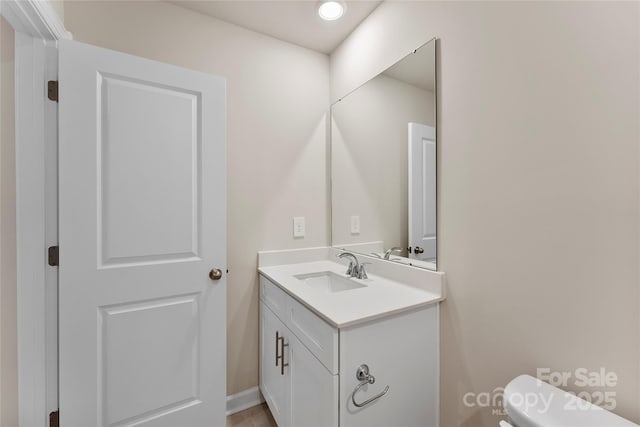 bathroom with toilet and vanity