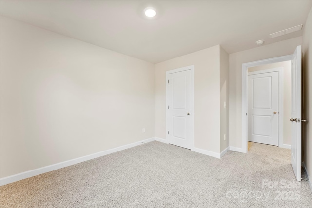 unfurnished bedroom featuring light colored carpet and a closet