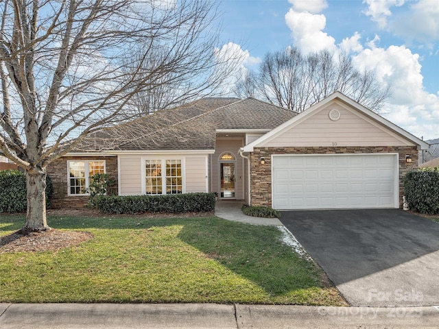 ranch-style home with a garage and a front lawn