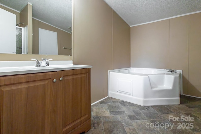 bathroom featuring a washtub, a textured ceiling, vanity, and crown molding