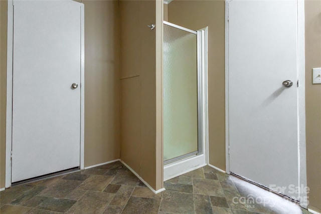 bathroom featuring a shower with shower door