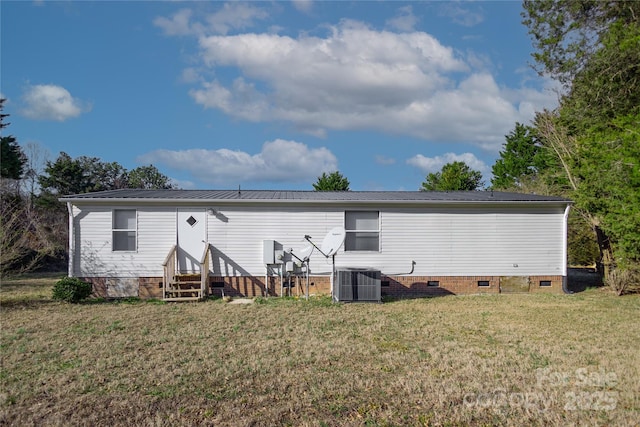 back of house featuring a lawn and central AC unit