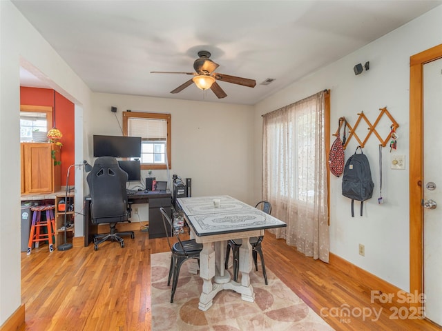 home office featuring ceiling fan and light hardwood / wood-style flooring