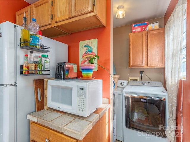 clothes washing area featuring separate washer and dryer