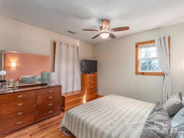 bedroom with light hardwood / wood-style flooring and ceiling fan