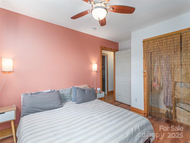 bedroom featuring ceiling fan and wood-type flooring