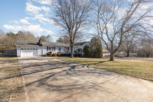 ranch-style home featuring a garage and a front lawn