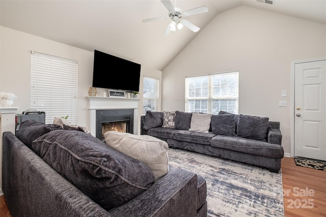 living room featuring high vaulted ceiling, hardwood / wood-style floors, and ceiling fan