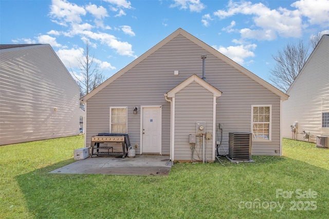 back of property with a jacuzzi, central AC, a yard, and a patio area