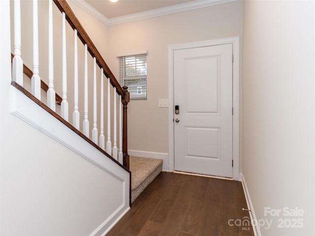 entryway with dark hardwood / wood-style flooring and crown molding