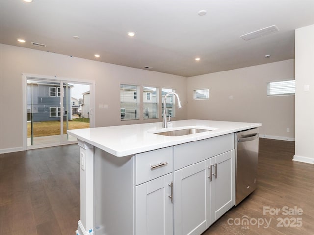 kitchen with dishwasher, white cabinetry, an island with sink, sink, and dark hardwood / wood-style floors