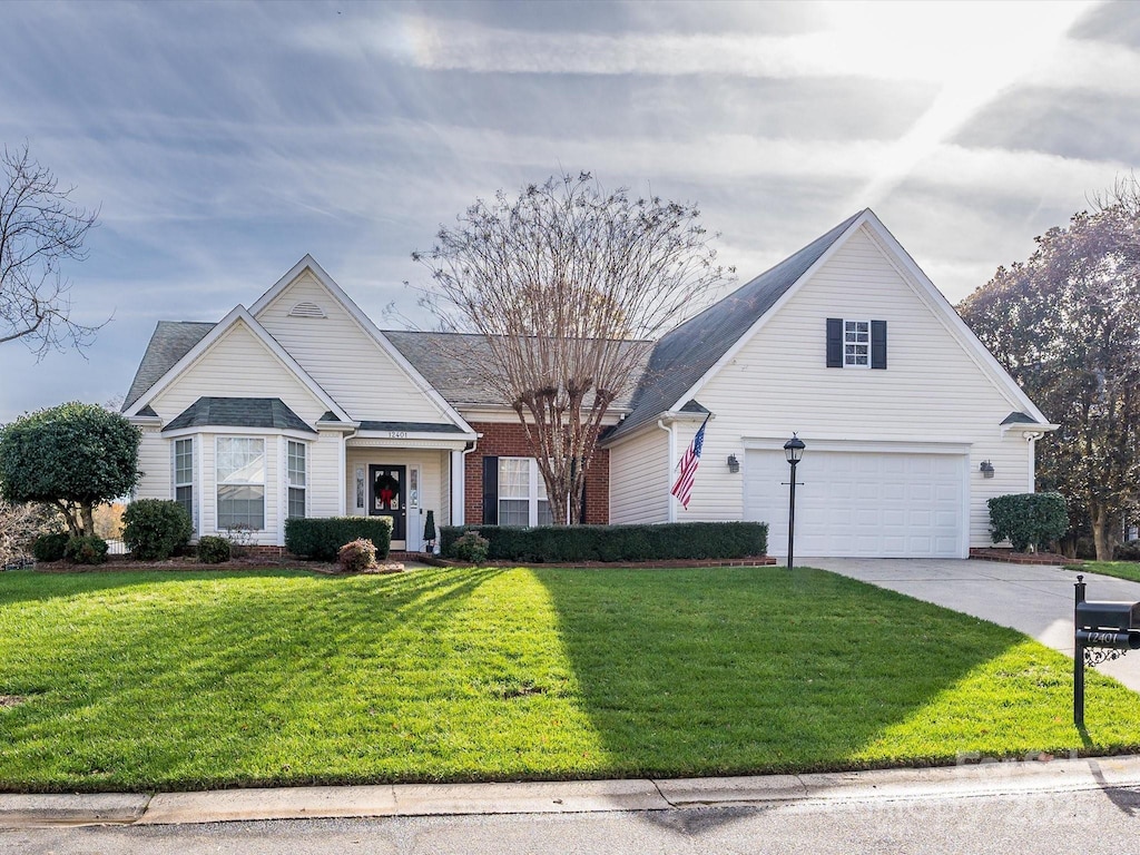 front of property with a front yard and a garage