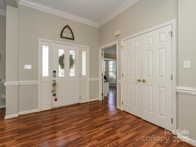 entryway featuring crown molding and dark hardwood / wood-style floors