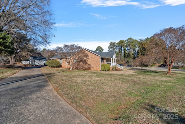 view of front of property with covered porch and a front lawn