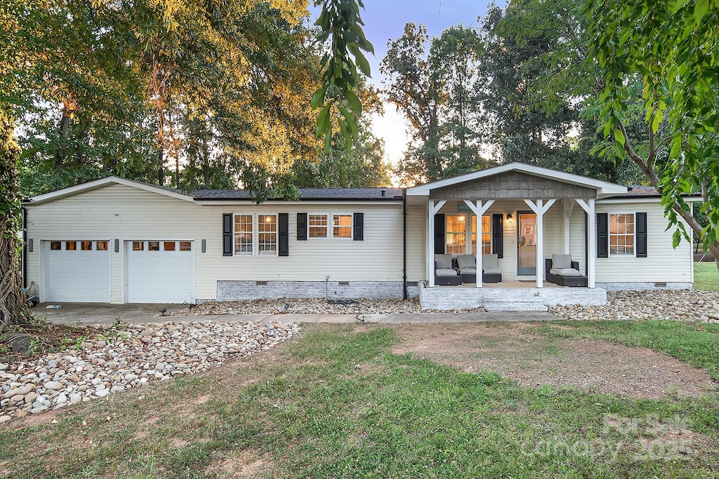 ranch-style house with covered porch and a garage