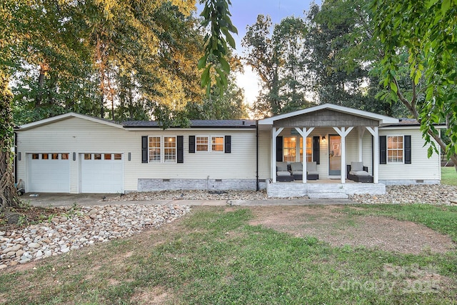 ranch-style house with covered porch and a garage